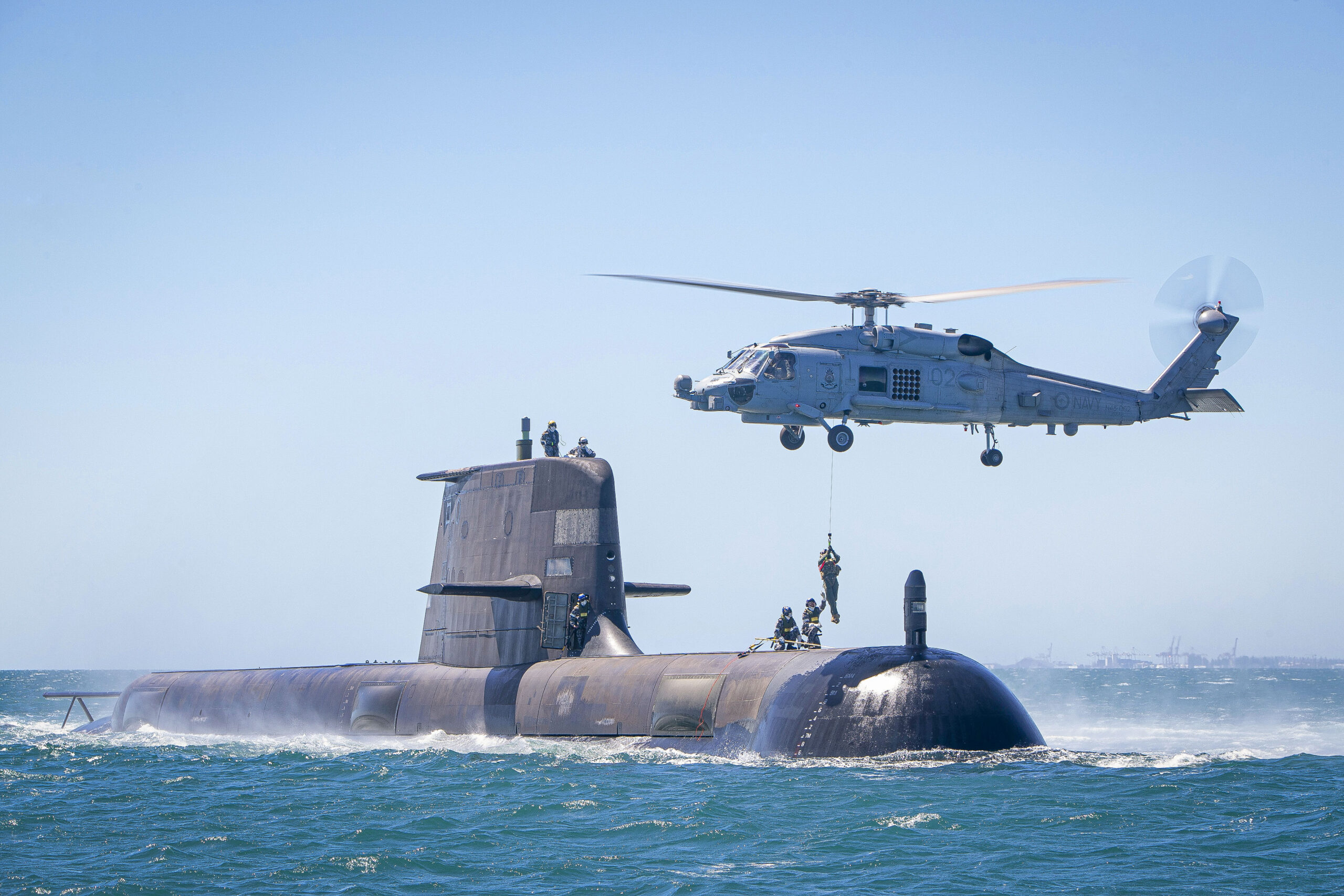 The <em>Collins</em> class submarine HMAS <em>Rankin</em> conducts helicopter transfers in Cockburn Sound, Western Australia, as part of training assessments to ensure the boat is ready to deploy. <em>Australian Department of Defense</em>
