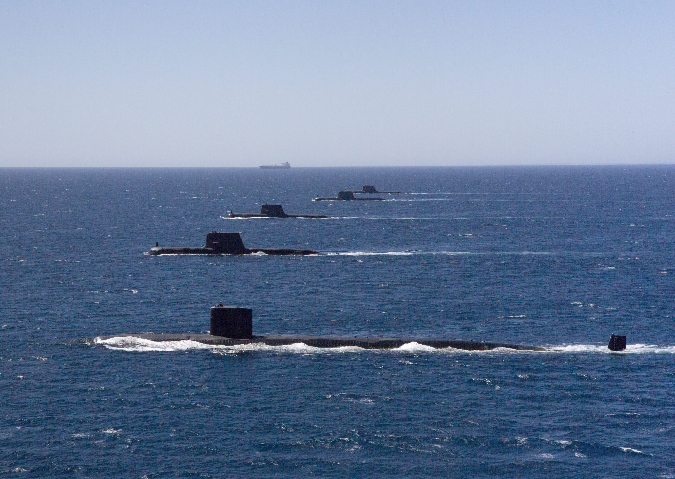 The <em>Los Angeles</em> class submarine USS <em>Santa Fe</em> transits in formation on the surface with Royal Australian Navy <em>Collins</em> class submarines HMAS <em>Collins</em>, HMAS <em>Farncomb</em>, HMAS <em>Dechaineux</em>, and HMAS <em>Sheean</em> in the West Australian Exercise Area, in February 2019. <em>Australian Department of Defense</em>